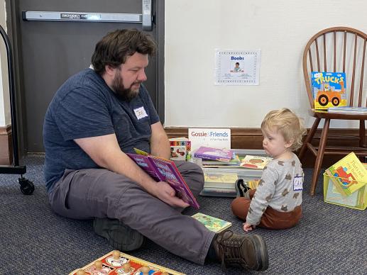 Father and son reading at the Family Place Workshop