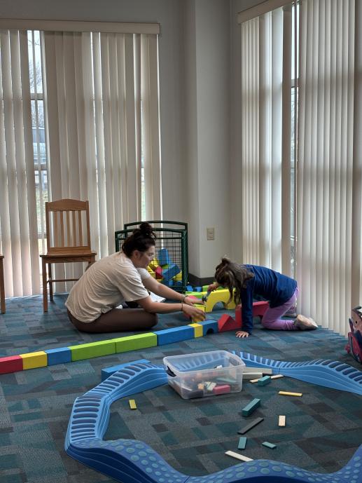 Parent and child playing with blocks in the Children's Room.