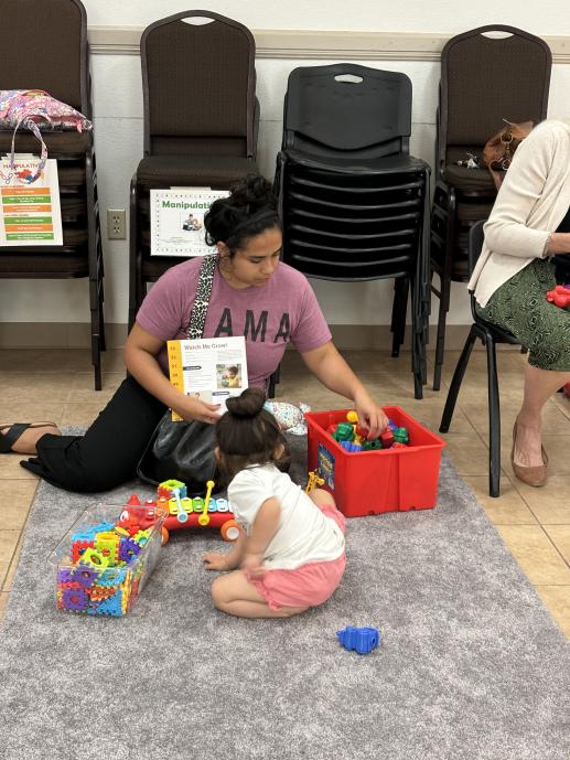 Parent and child playing with manipulatives during Parent-Child Workshop.