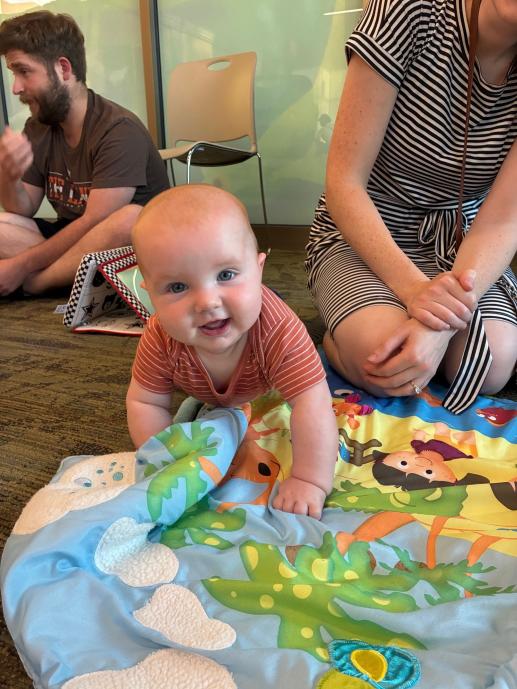 Baby using tummy time mat from toy collection 