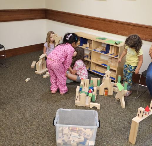 Children playing on the floor with blocks