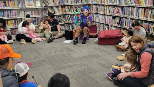 Musical educator from Love Bug and Me Music leading workshop participants in a song.