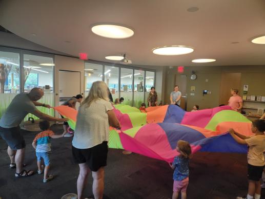 Families during the Parent Child Workshop playing parachute games.