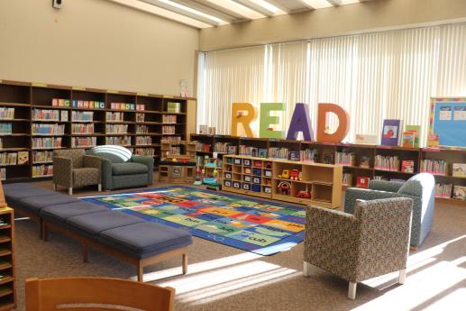 Youth Services Department's play area at the library filled with books and toys.