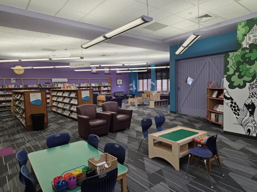 Smoky Hill Library's children space with a writing table, Duplo table, and children's collection.