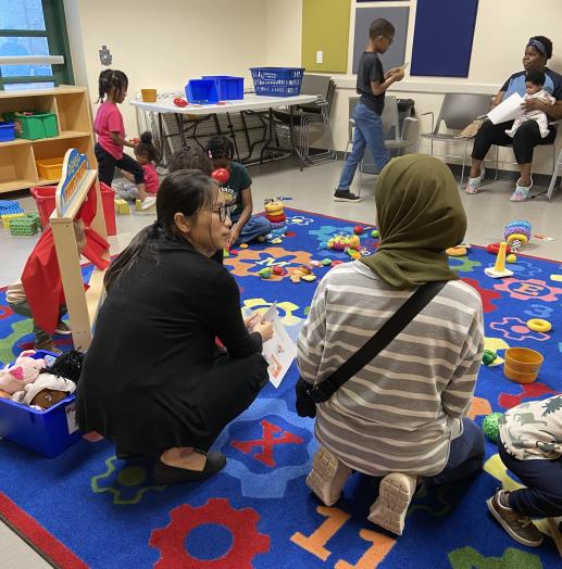 Family Workshop - pediatrician talking with mother while children play