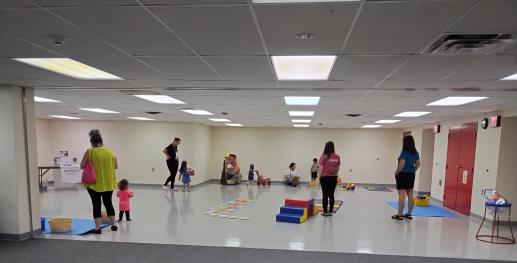 Grown ups and kids playing during Play & Learn program.