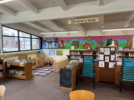A wider look at Blyden Library's Kidzone, including shelves featuring our Family Resource Center.