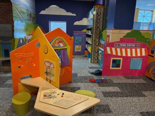 Play cafe and shelves with bins of toys