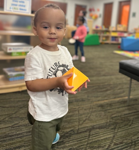 Child with toy in youth program room