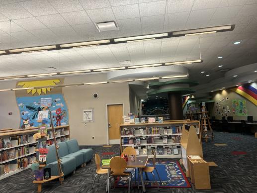 Our Children's area space includes several tables for passive activities, a dramatic play station, and book displays. 