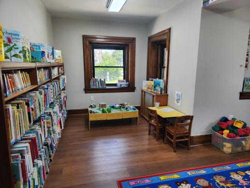 Portion of the children's room, featuring books, writing station, and train table.