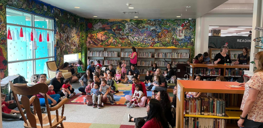 Picture of Dr. Seuss storytime audience with the Children's Win Mural in the background.