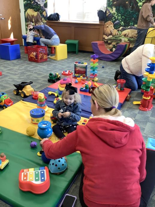 Kids and parents/caregivers playing during the Parent Toddler Workshop program.