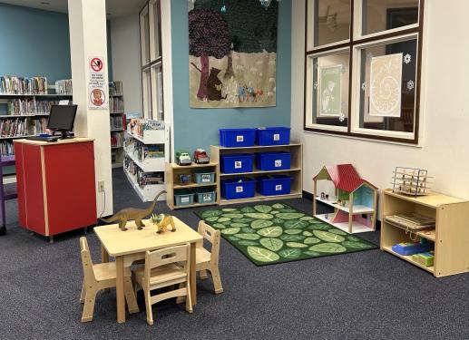 A children's play area with toys in bins