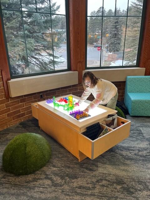 A child interacts with a light table