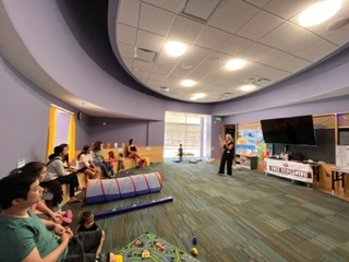 Family Place Workshop. Caregivers are seating watching presentation.