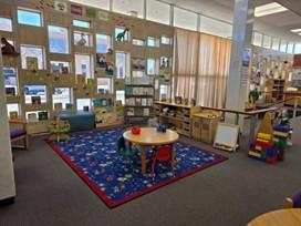 Family place space in the children's area at Howard County Library. Picture shows toys, manipulatives, books, art table for children 0-3. 