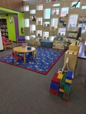 Family place space in the children's area at Howard County Library. Picture shows toys, manipulatives, books, art table for children 0-3.