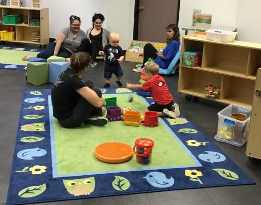 Parents and children playing with toys during Family Place Workshop.