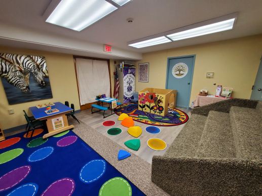 A colorful, welcoming room with various stations filled with age-appropriate toys that encourage a fun, learning experience