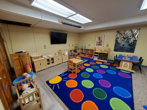 A colorful, welcoming room with various stations filled with age-appropriate toys that encourage a fun, learning experience