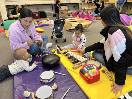 Playgroup participants exploring musical instruments