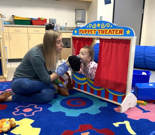 parent playing puppets with young child