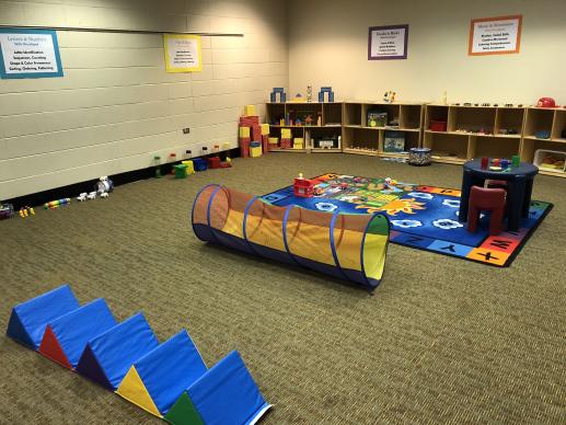 A colorful display of toys, activities, and games for young children in our community room at Lafayette Branch Library