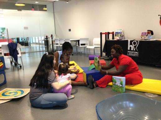 Literacy presenter engaging with parents and children