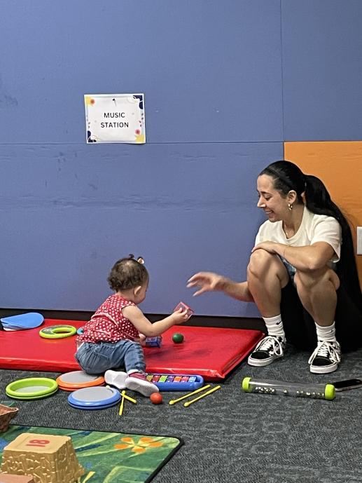 A mother and daughter engaging in play.