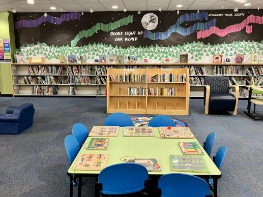 Puzzle table and board books in front of display board