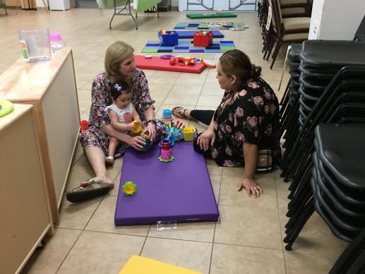 Community Professional conversing with a parent during our spring Parent-Child Workshop.