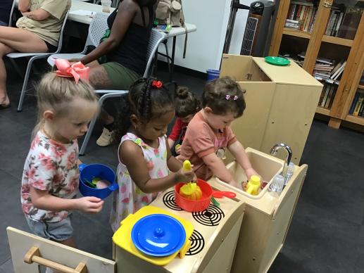 Children playing in play kitchen