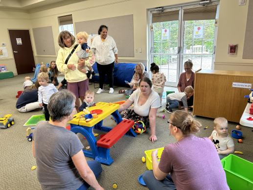 caregivers and children engaging in gross motor, play kitchen areas