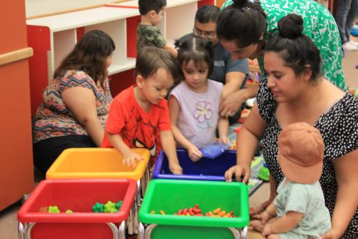 Parents and children interacting during a Parent/Child Workshop at Camarena Memorial Library