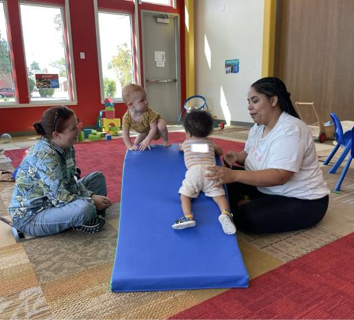 Adult connecting with an early childhood professional at the Play & Learn workshop.