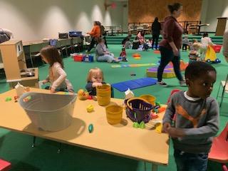 A Fun Under Five session in our Community Room showing children playing with the kitchen items as well as other activities.