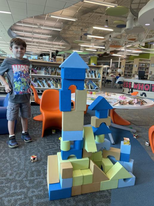 Early childhood play area, a boy and his family built a block castle