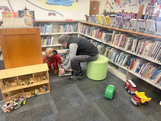 Grandfather and child playing with toys in the Children's area