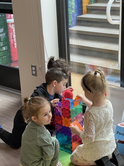 group of pre-schoolers building with magnetic blocks
