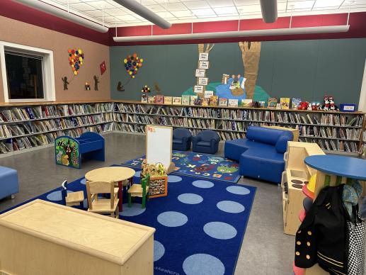 Family Place children's area at the Octavia Fields Library, showing bins, kid's chairs and toys.