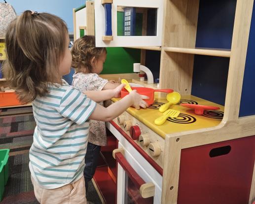 Two children playing with Family Place Kitchen