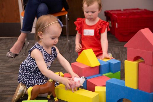 Children playing with foam blocks and toys.