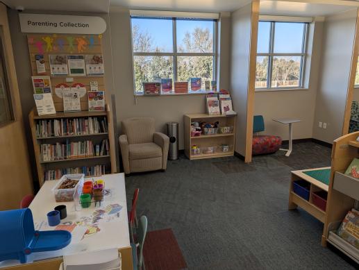 Eloise May Library's children's space includes a parenting collection, toys, and seating for families to enjoy.