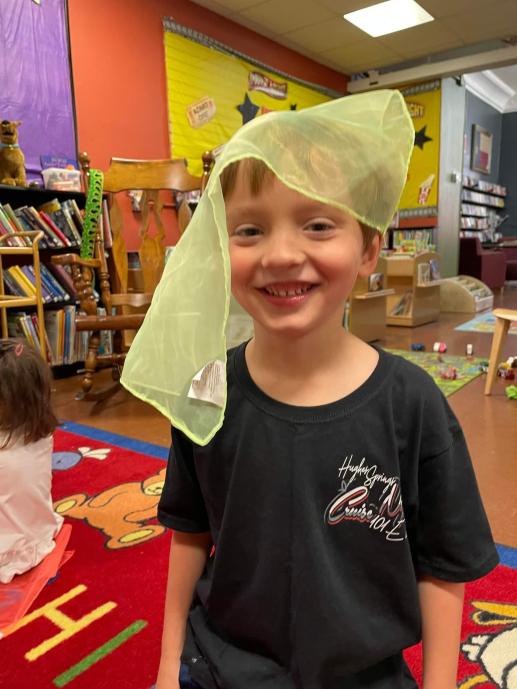 Boy playing with scarves during music and movement time at Stay & Play.