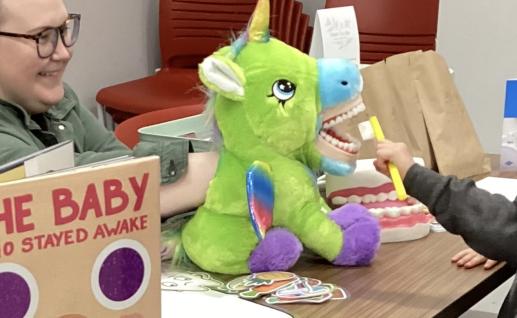 Pediatric dentist interacts with children and families at our Play, Learn and Grow session