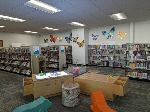 Tri-table with light fixture, Duplos, and train sets.
