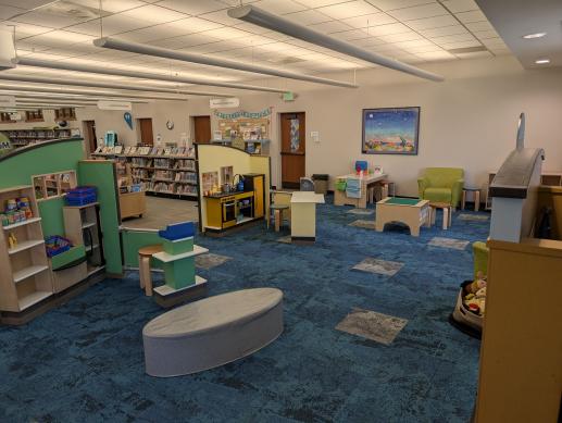 Koelbel Library children's space with play market, play cafe, and puppet theater.