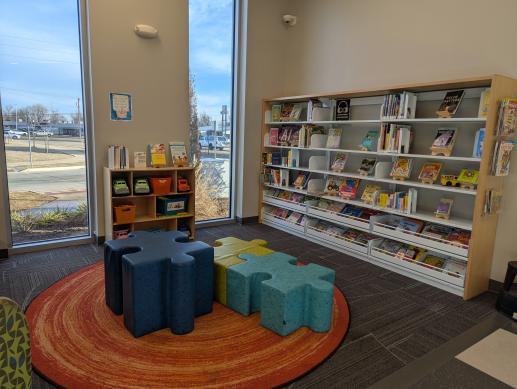 Picture of caregiver resources on top of toy shelf and board book reading area.